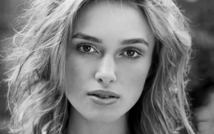 A striking black-and-white close-up of Keira Knightley, showcasing her captivating features. This HD desktop wallpaper beautifully highlights her elegance and charisma.