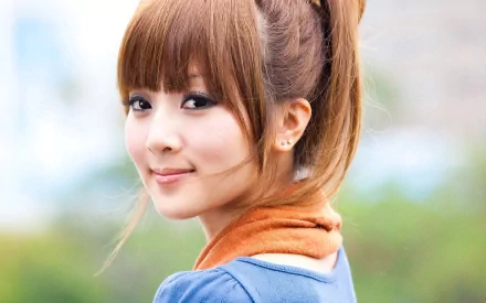 HD desktop wallpaper featuring an oriental Asian woman, Mikako Zhang Kaijie, with a serene expression, soft background, and light outdoor setting.