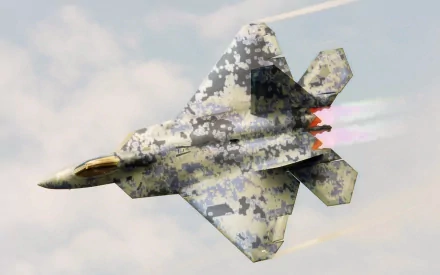 A Lockheed Martin F-22 Raptor soaring through the sky, showcasing its camouflage design and afterburners, set against a backdrop of clouds. High-definition military wallpaper.