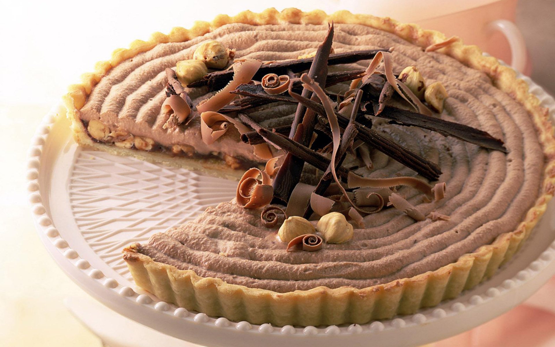 HD desktop wallpaper featuring a close-up of a rich chocolate cream tart topped with chocolate shavings on a white plate.