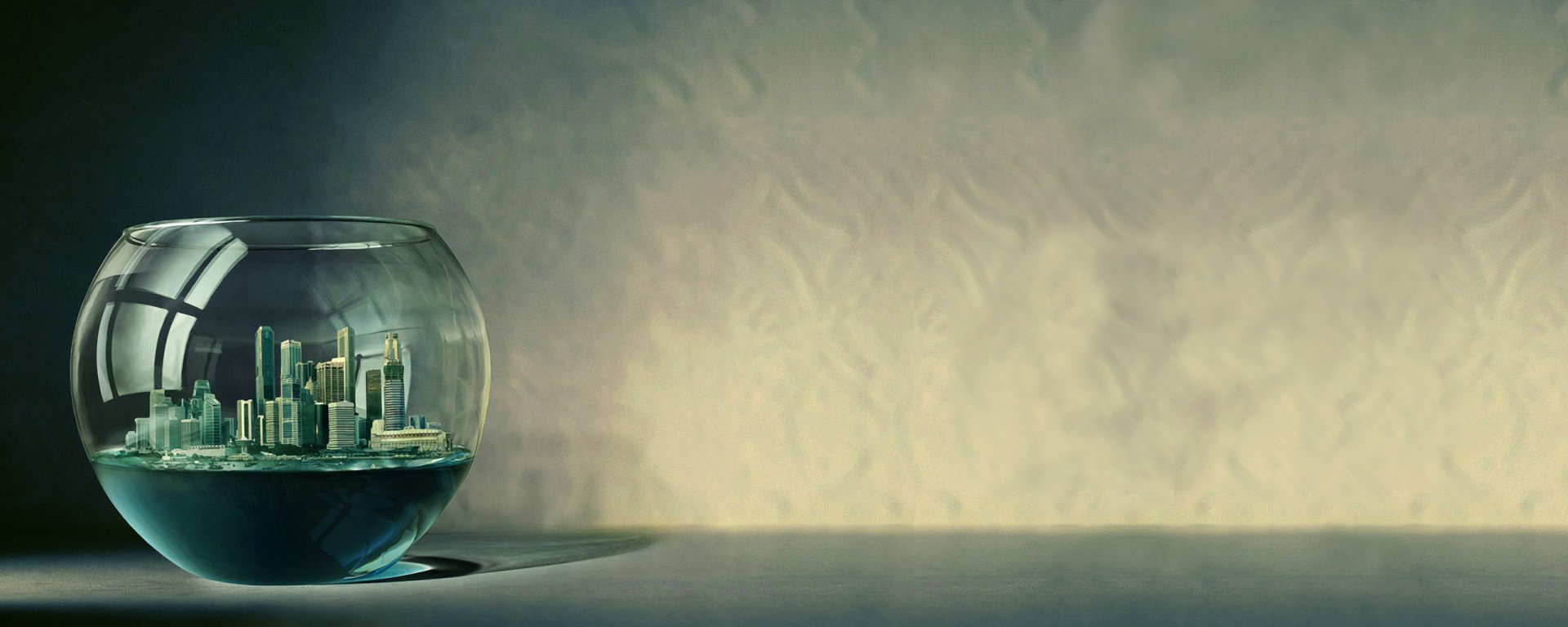 A glass bowl containing a miniature cityscape sits on a surface, showcased against an artistic textured background, creating a captivating man-made scene.