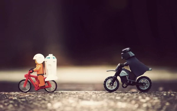 A playful scene features LEGO figures of Luke Skywalker on a bike and Darth Vader on a motorcycle, capturing a whimsical moment in a Star Wars-inspired design.