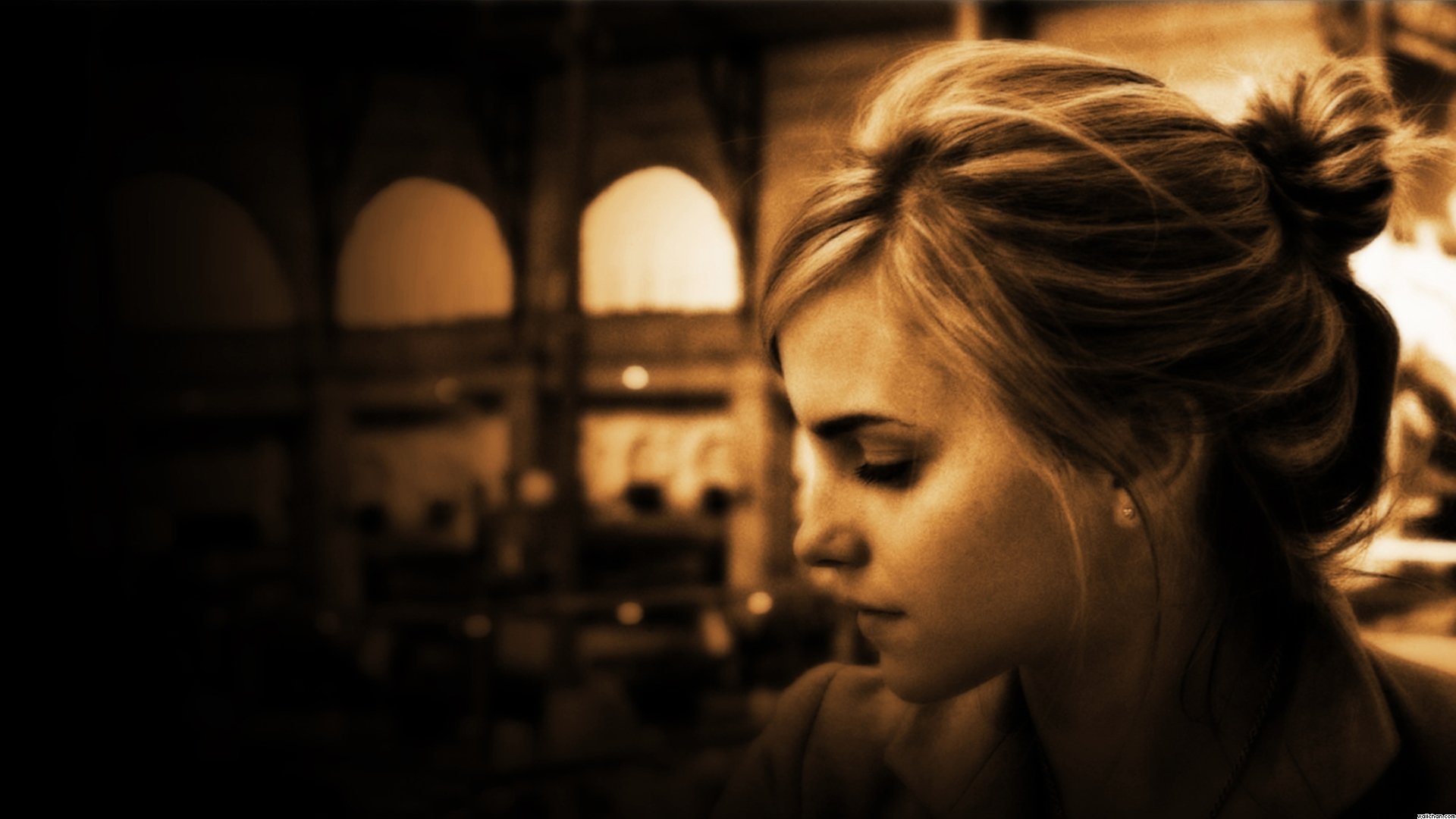 HD PC desktop wallpaper featuring a sepia-toned close-up of celebrity Emma Watson with a blurred indoor background.
