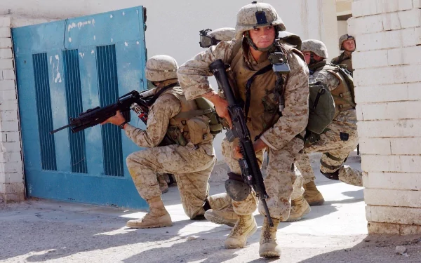 U.S. Army Infantry soldiers in full military gear armed with guns, positioned tactically during a combat operation, captured in HD for a desktop wallpaper background.