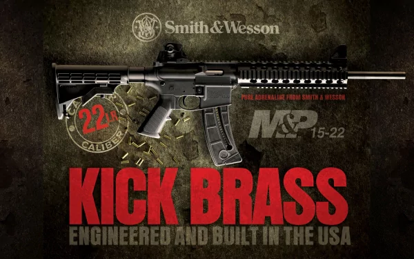 HD desktop wallpaper featuring a Smith & Wesson submachine gun. The design prominently displays the tagline KICK BRASS, emphasizing its engineering and construction in the USA.