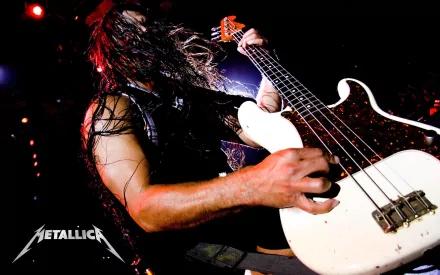 A dynamic shot of a bassist performing on stage, emphasizing intense energy and movement, surrounded by vibrant concert lights, with the Metallica logo featured prominently.