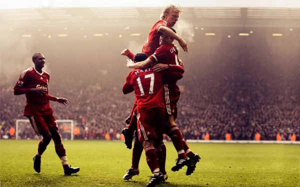 HD desktop wallpaper featuring Liverpool F.C. players celebrating a goal during a match, capturing the excitement and energy of the sport.
