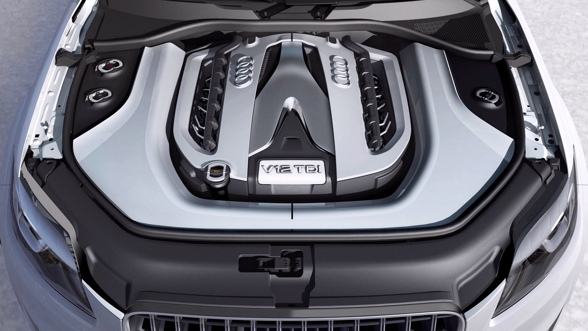 HD PC desktop wallpaper of a vehicle engine bay — close-up of a V8 TFSI engine cover, sleek metallic lines and components forming a crisp high-resolution background.