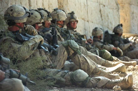 HD wallpaper of soldiers in military uniforms sitting and resting against a wall. The image is tagged with army, military, and soldier.