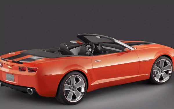 Orange Chevrolet Camaro convertible, rear three-quarter view on a neutral studio backdrop — HD PC desktop wallpaper and background.