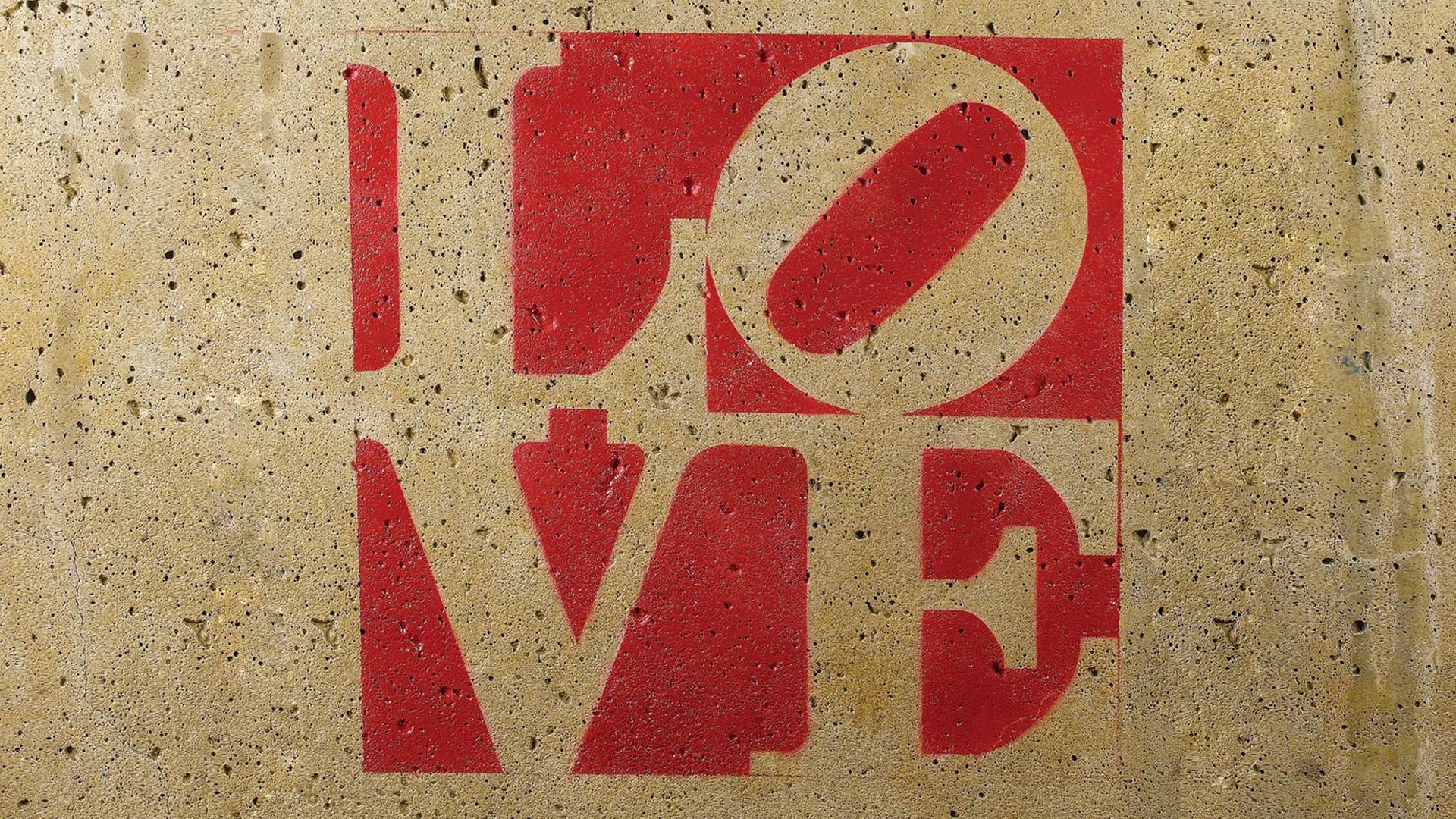 Artistic HD desktop wallpaper featuring the word LOVE in bold red letters against a textured beige background, symbolizing love with a modern, graphic design.