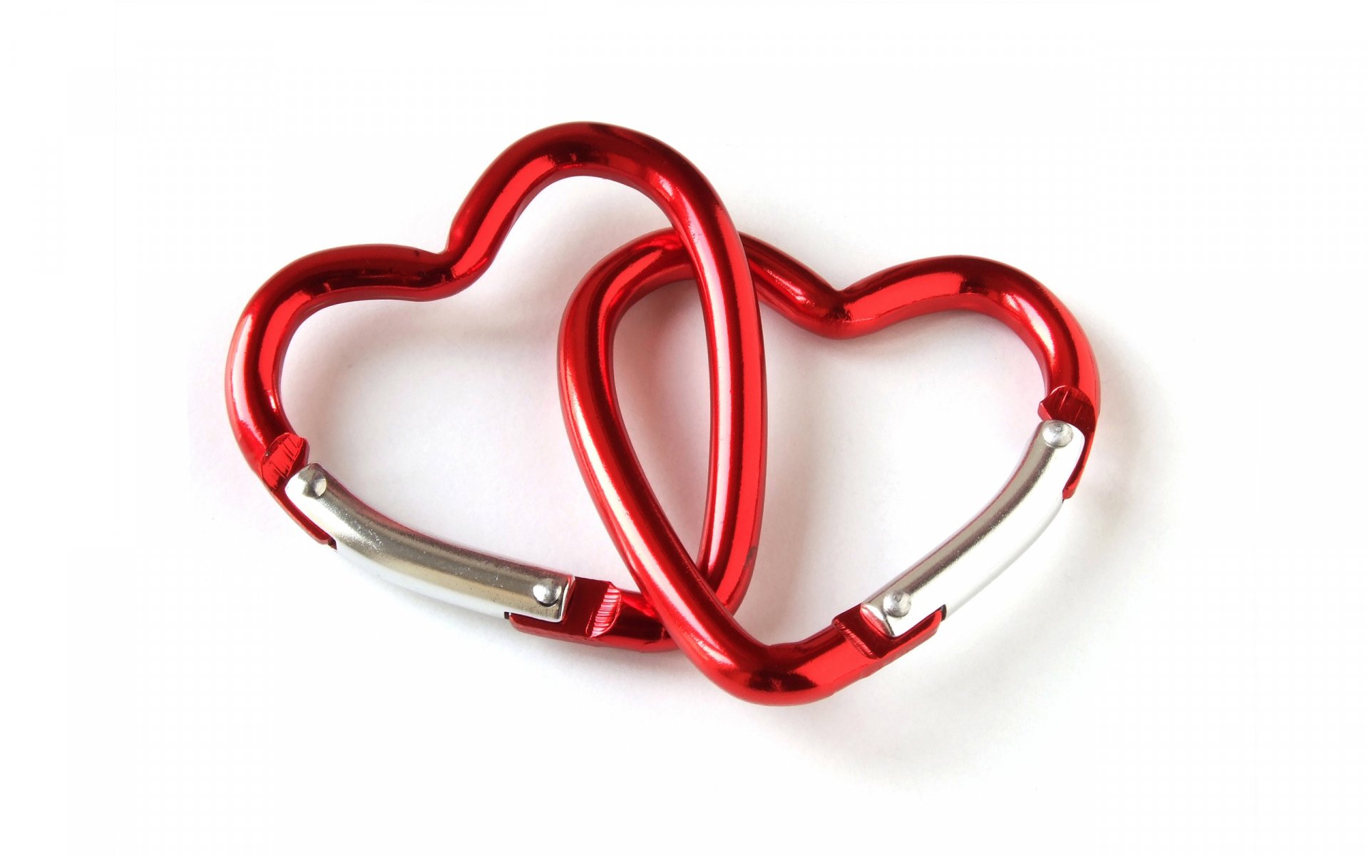 Two interlocking red heart-shaped carabiners symbolize love, set against a clean background, making a striking artistic desktop wallpaper for your PC.