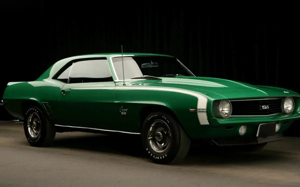 HD PC desktop wallpaper showing a classic green muscle vehicle with a white roof and racing stripes against a dark studio backdrop.
