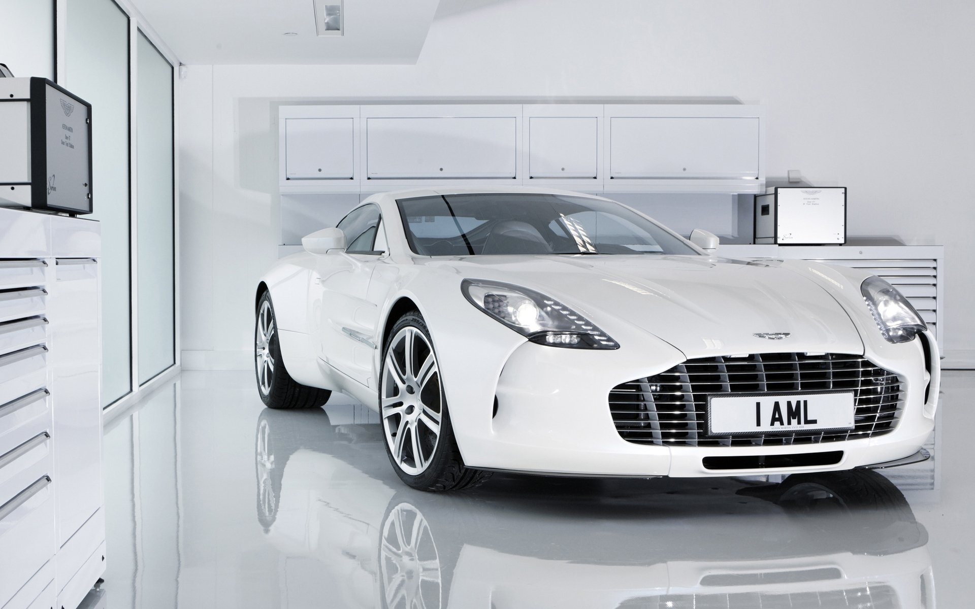 White Aston Martin One-77 parked in a glossy minimalist garage, high-resolution HD PC desktop wallpaper and background.