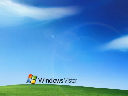 HD desktop wallpaper featuring the classic Windows Vista logo over a bright blue sky with wispy clouds and a green rolling hill, showcasing Microsoft technology.