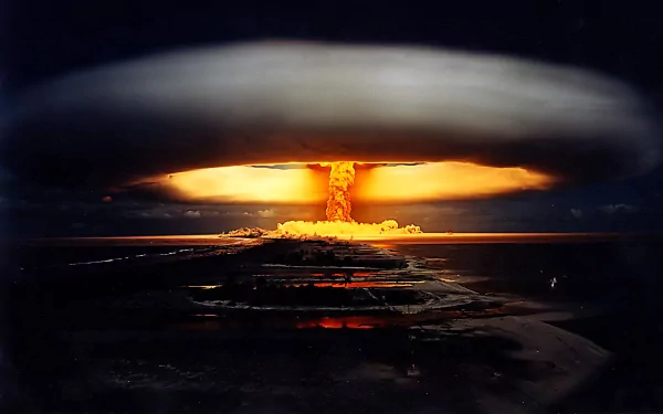 A dramatic HD wallpaper featuring a large explosion with a mushroom cloud, capturing the intensity of military power and destructive force against a darkened sky.