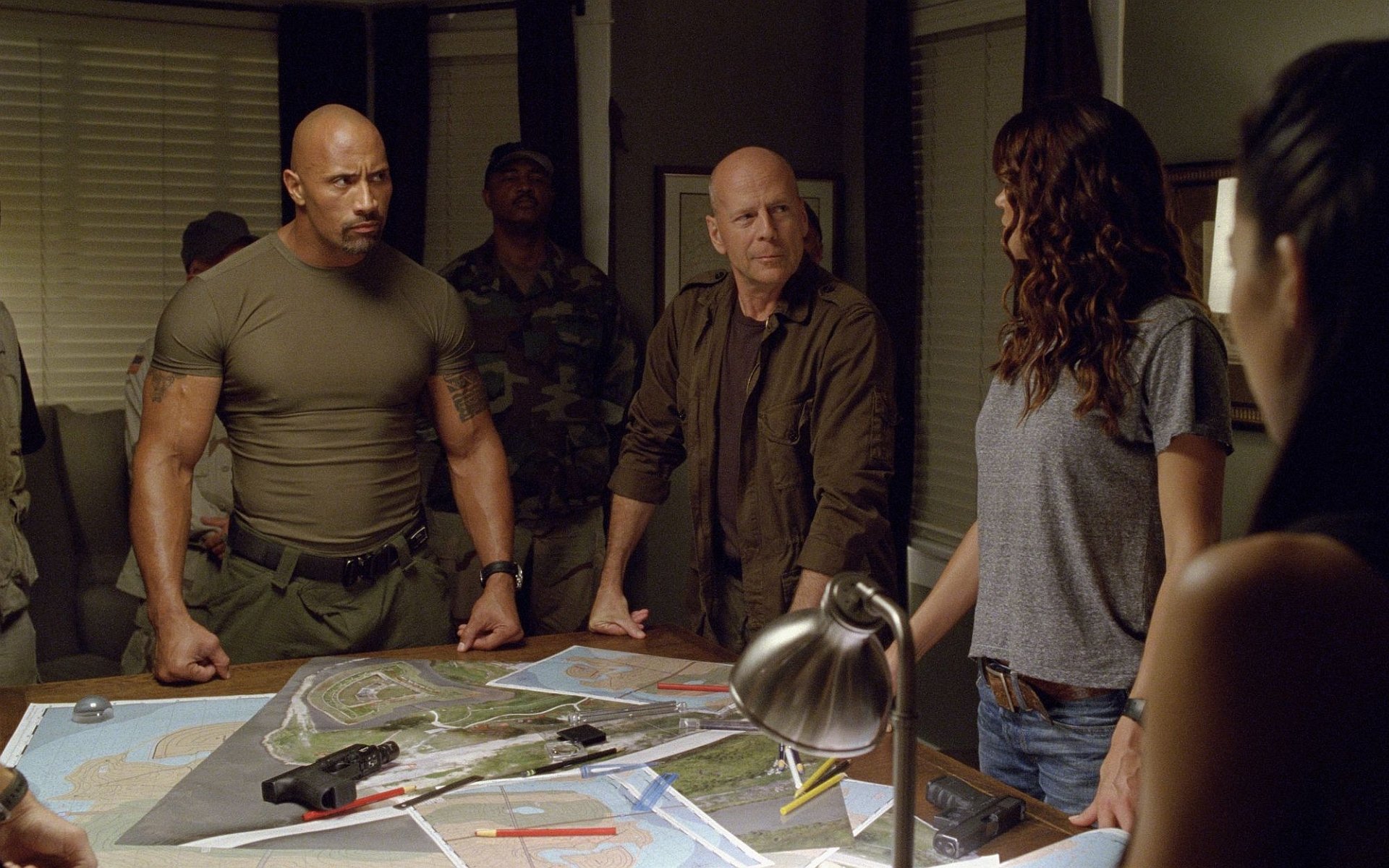 HD PC desktop wallpaper featuring a tense planning scene from the movie G.I. Joe: Retaliation with key characters gathered around a table.