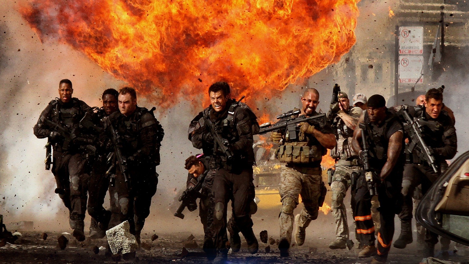 HD PC desktop wallpaper featuring an intense action scene from the movie Transformers: Dark of the Moon with armed soldiers running from a massive explosion.