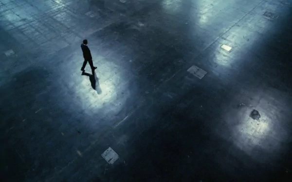 A solitary man stands reflecting alone in a dark, expansive space, evoking themes of solitude and introspection in this HD PC desktop wallpaper.