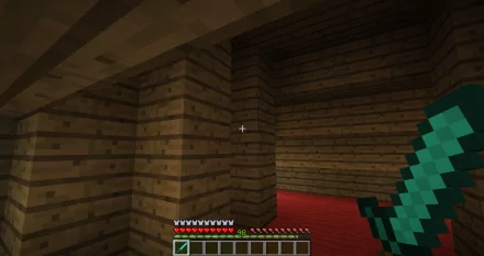 A Minecraft scene featuring a player perspective inside a wooden structure with a red floor, showcasing a diamond sword and the game's iconic user interface.
