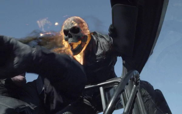 HD PC desktop wallpaper background from the movie Ghost Rider: Spirit of Vengeance — flaming-skulled Ghost Rider lunging on a motorcycle against a clear blue sky.