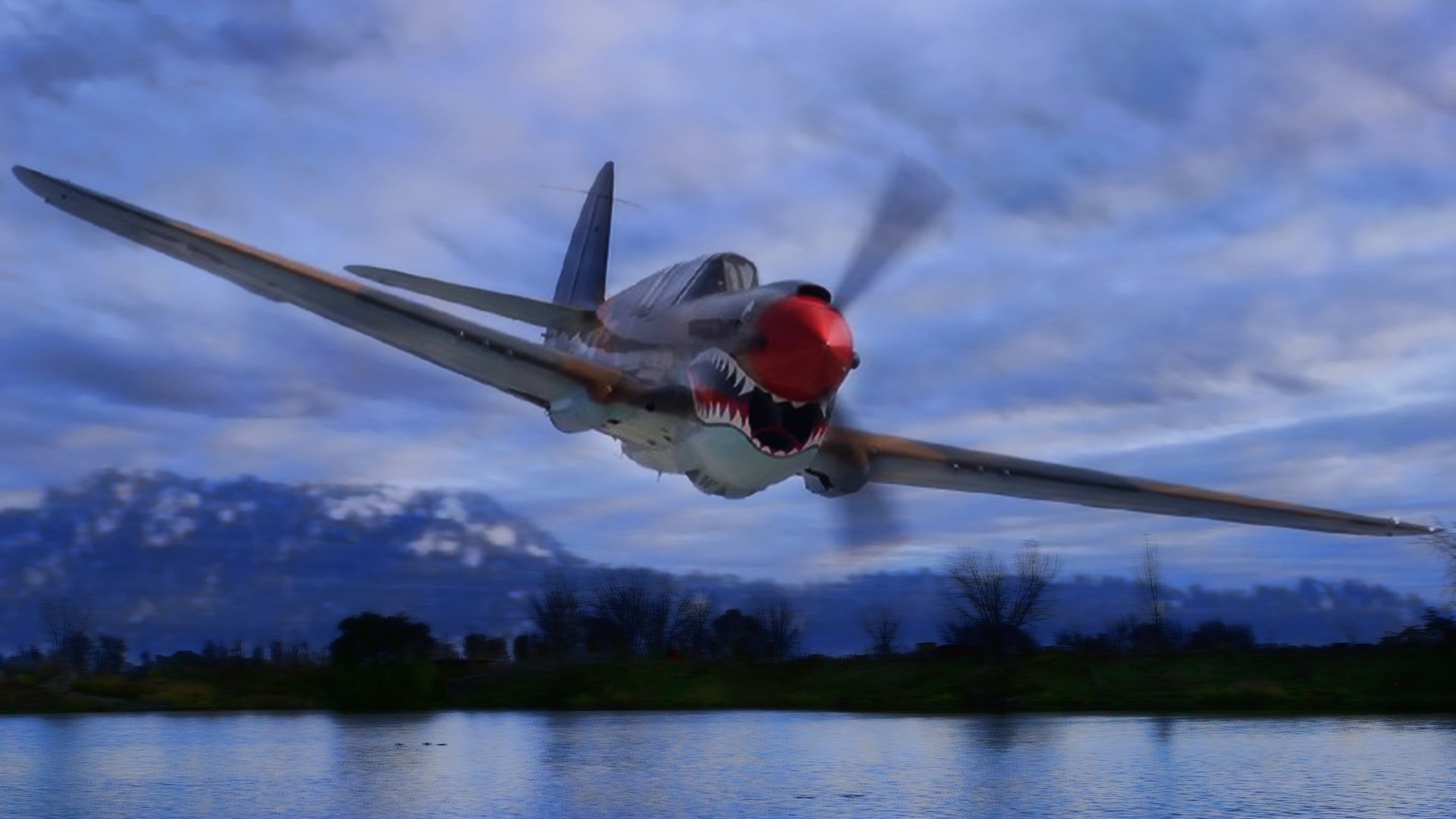 HD PC desktop wallpaper featuring a military aircraft in flight over a reflective body of water with mountains and a cloudy sky in the background.