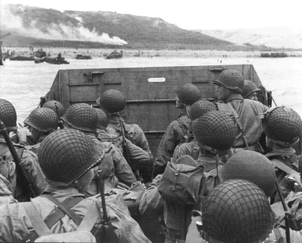 Black and white historic image of soldiers in a landing craft during D-Day, used as an HD desktop wallpaper and background.