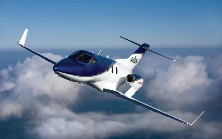 Honda HA-420 HondaJet aircraft soaring above clouds — HD PC desktop wallpaper and background.