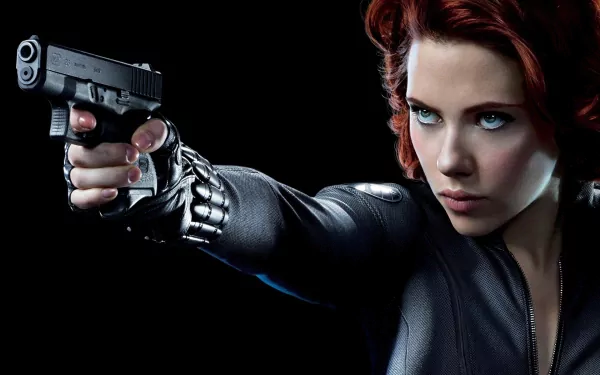 Natasha Romanoff, portrayed by Scarlett Johansson, aims a gun in this striking HD wallpaper from The Avengers, showcasing her fierce and determined character as Black Widow.