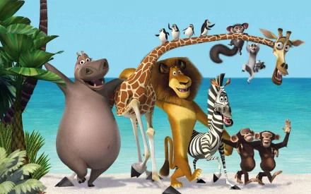A vibrant HD wallpaper featuring characters from Madagascar 3: Europe's Most Wanted, including a hippo, lion, giraffe, zebra, and playful monkeys against a beach backdrop.