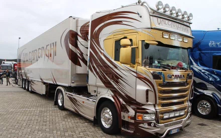 A striking Scania truck with an eye-catching design, parked on a paved area. This HD image serves as a dynamic desktop wallpaper and background.