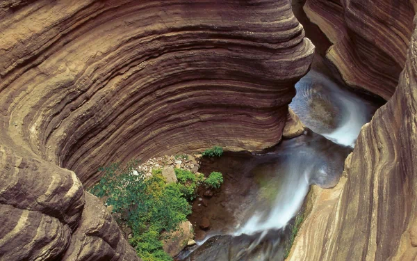 A serene view of the Grand Canyon, showcasing majestic rock formations and flowing water, captured in high definition for a stunning desktop wallpaper.