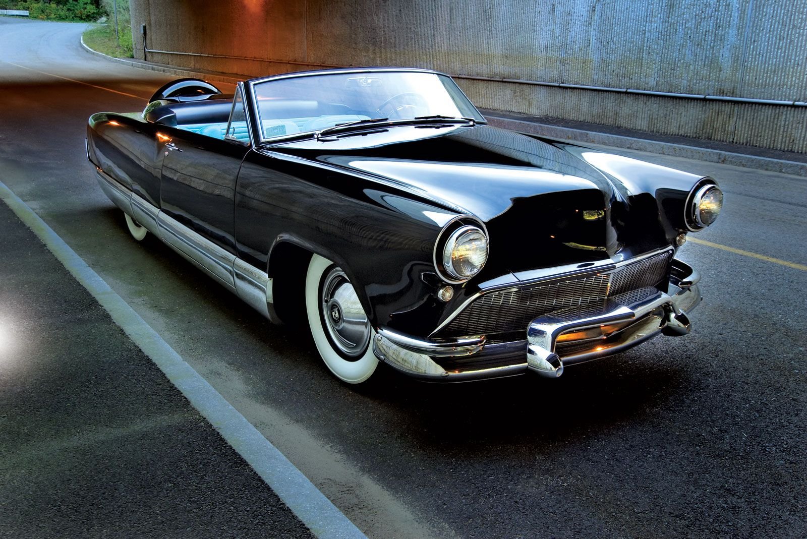 Glossy black vintage convertible vehicle/car with chrome trim and whitewall tires parked on a wet road — HD PC desktop wallpaper and background