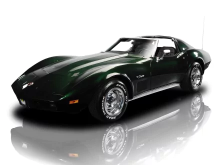 HD PC desktop wallpaper background: dark green Chevrolet sports car with chrome wheels reflected on a glossy white studio surface.