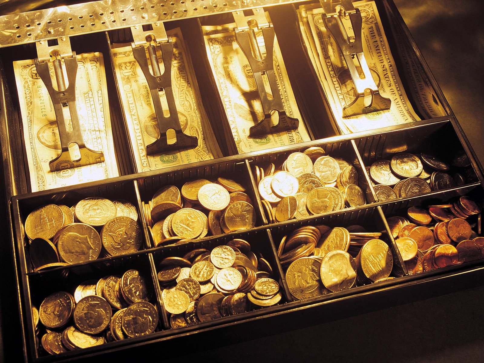 A high-definition PC wallpaper featuring a cash register filled with neatly organized coins and bills, showcasing the concept of money in a vibrant setting.