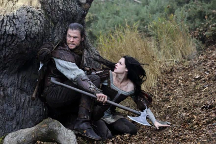 Chris Hemsworth and Kristen Stewart in a scene from the movie Snow White and the Huntsman, featured as an HD PC desktop wallpaper and background.