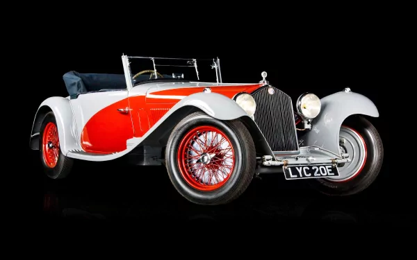A vintage Alfa Romeo car with a striking red and gray design, showcasing its classic charm against a sleek black background. A high-definition desktop wallpaper option.