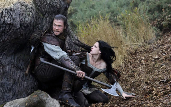 Chris Hemsworth and Kristen Stewart in a scene from the movie Snow White and the Huntsman, featured as an HD PC desktop wallpaper and background.