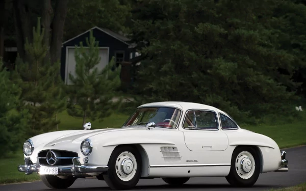 HD desktop wallpaper featuring a classic white Mercedes-Benz 300SL parked on a road with a lush green forest background.