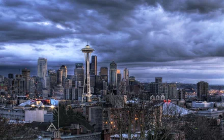 HD PC desktop wallpaper/background showing Seattle's skyline under stormy clouds, the man-made Space Needle towering above city skyscrapers.