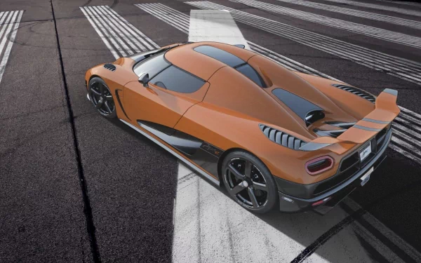 A striking Koenigsegg Agera R parked on a sleek surface, showcasing its aerodynamic design and vibrant orange color. An eye-catching HD desktop wallpaper for automotive enthusiasts.