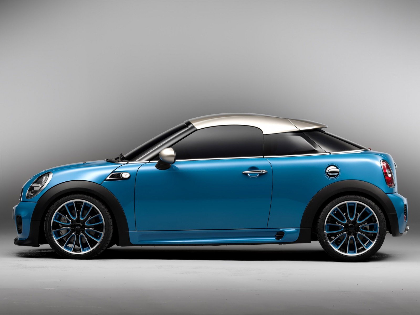 Blue Mini Cooper vehicle in side profile on a neutral gray backdrop — HD PC desktop wallpaper.