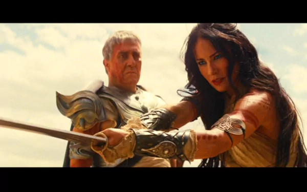 HD PC desktop wallpaper from the movie John Carter featuring two characters in battle-ready poses with armor and weapons against a bright sky backdrop.