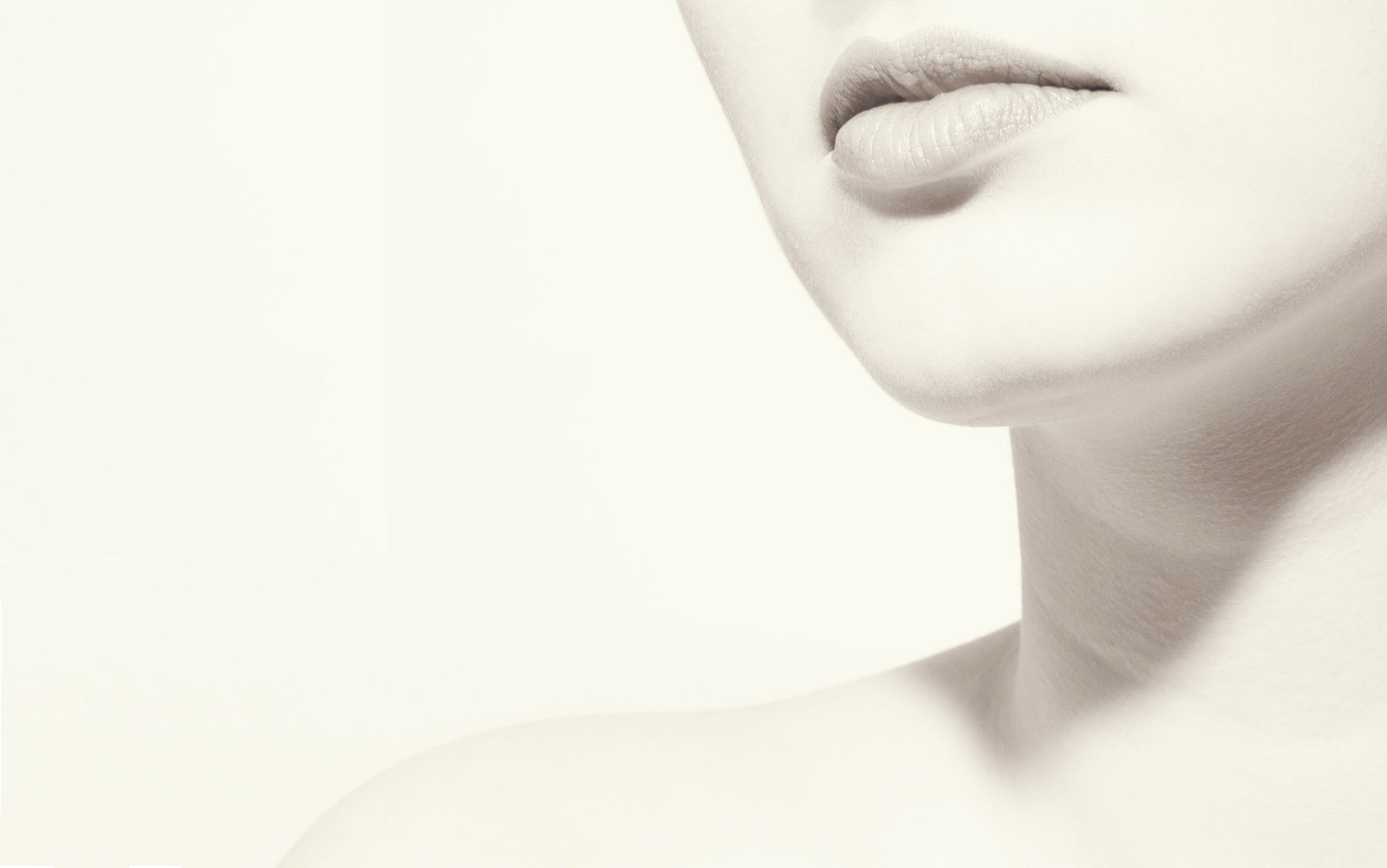 Close-up of a woman's sensual features, showcasing her lips and neck in a soft, minimalist style, designed as an HD desktop wallpaper and background.