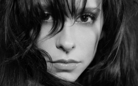 Black and white HD desktop wallpaper and background featuring a close-up of the celebrity Jennifer Love Hewitt with dark, flowing hair and an intense gaze.