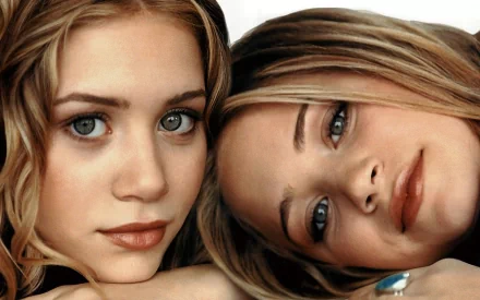 A close-up portrait of the Olsen Twins, showcasing their distinct features and expressions, serves as a high-definition PC desktop wallpaper and background.