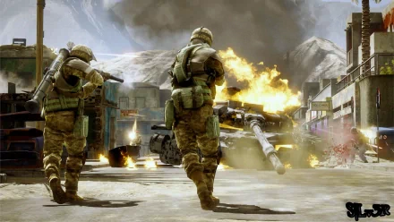 Two soldiers advance on a battlefield engulfed in flames, showcasing intense action from the video game Battlefield: Bad Company 2. An HD wallpaper capturing the chaos of war.