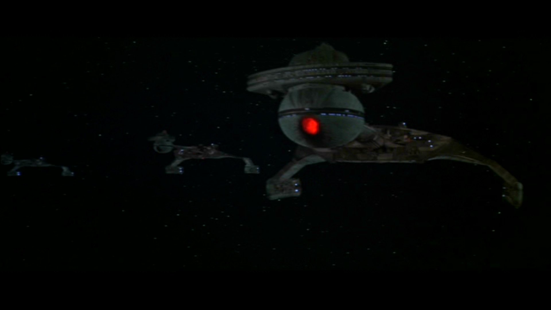 HD PC desktop wallpaper featuring a dark space scene from the movie Star Trek: The Motion Picture, showcasing iconic starships and a glowing red light.