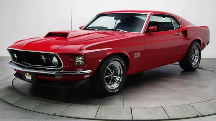 HD PC desktop wallpaper featuring a vibrant red Ford Mustang Boss 429, showcasing its classic muscle car design in a sleek studio setting.
