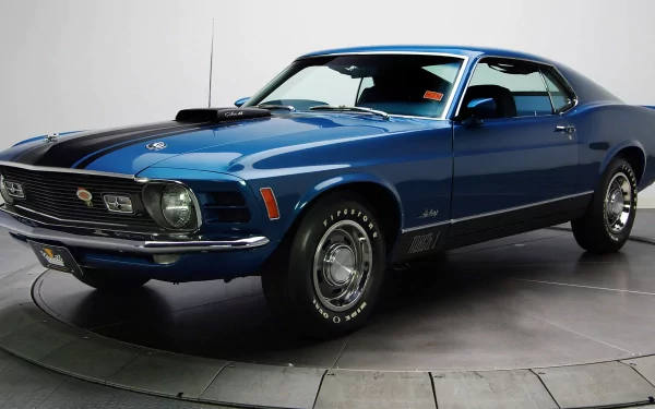 HD PC desktop wallpaper of a blue Ford Mustang Mach 1 muscle vehicle, three-quarter front view on a studio floor.